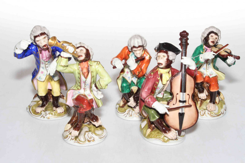 Continental porcelain five piece monkey band, four Dresden, average 16cm high.