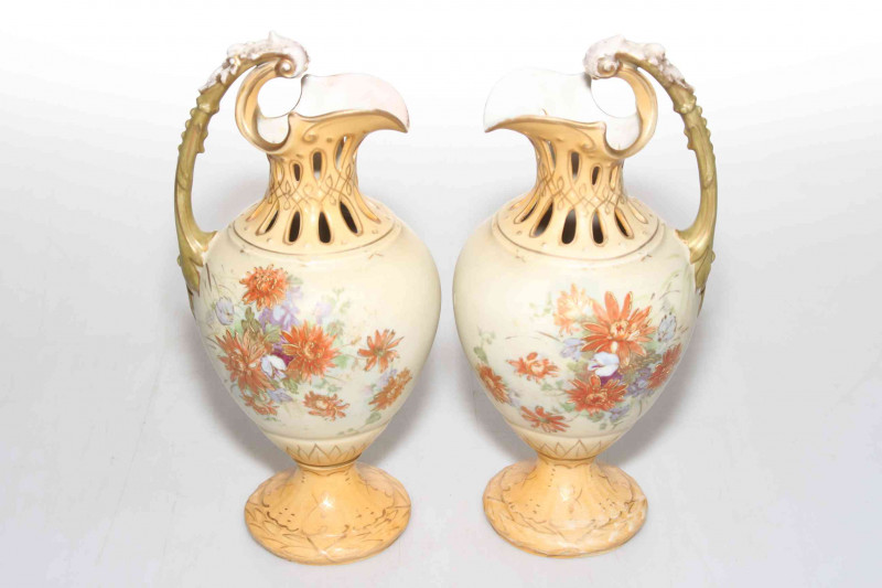 Pair Royal Vienna blush ewers with flower decoration, 24cm.