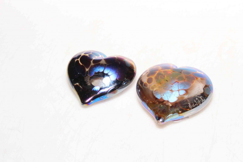 Two John Ditchfield heart shaped paperweights.