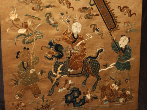 Framed Chinese silkwork depicting a Gentleman Riding a Dragon with Two Figures on Foot, in glazed frame, 49.5cm by 47.5cm including frame. thumbnail