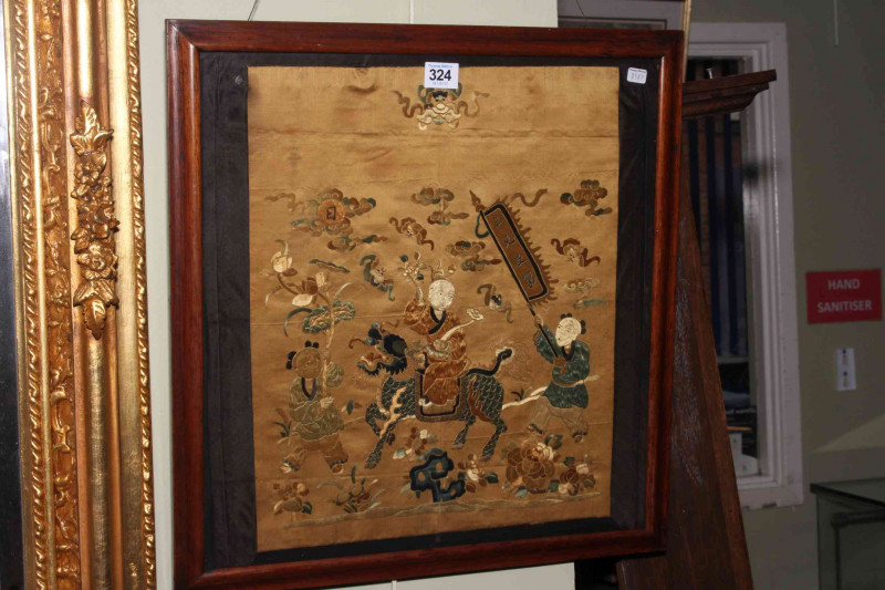 Framed Chinese silkwork depicting a Gentleman Riding a Dragon with Two Figures on Foot, in glazed frame, 49.5cm by 47.5cm including frame.