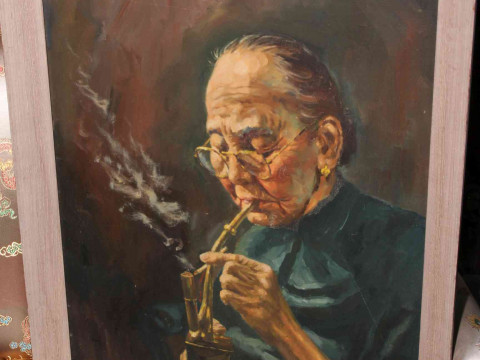 W.M. Chan, Elderly Oriental Lady Pipe Smoking, oil on board, signed lower...