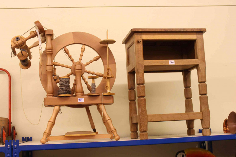 Burr and oak three tier side table with fox mask motif, 61cm by 44.5cm by 30cm and antique style spinning wheel (2).