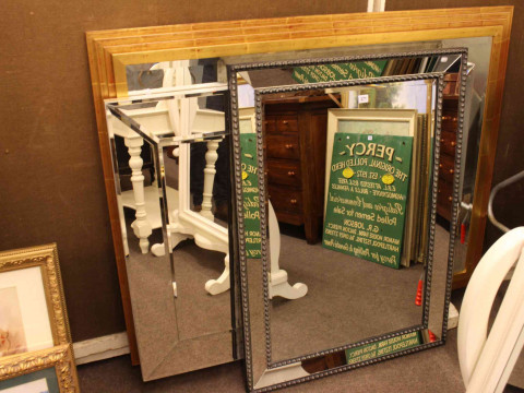 Three contemporary bevelled wall mirrors (largest 138cm by 108cm).
