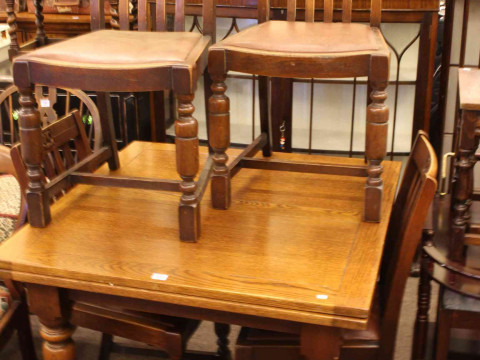 Oak draw leaf dining table and four chairs.