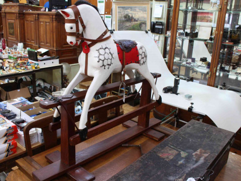 Small sponge painted rocking horse on stained safety stand, 93cm by 111cm. thumbnail