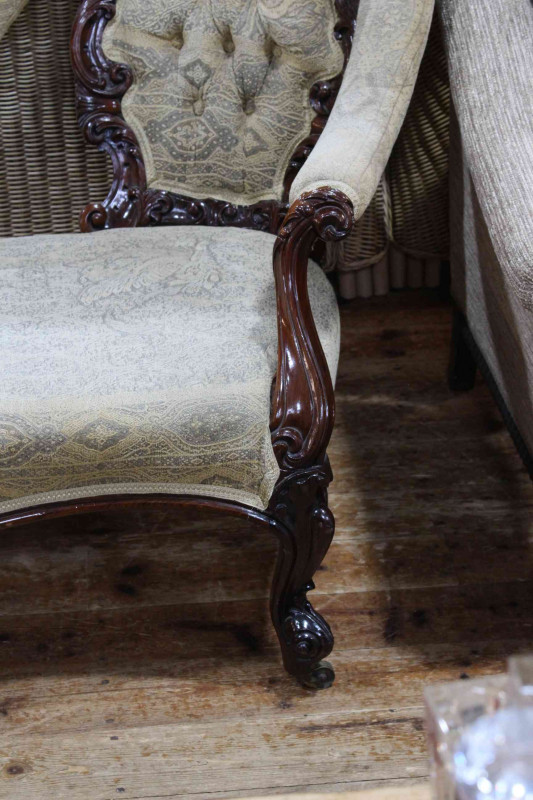 Victorian mahogany double button backed settee with serpentine front seat.