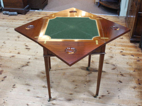 Edwardian inlaid mahogany envelope card table on square tapering legs bearing label for W.F. Greenwood & Sons, York, 74cm by 55.5cm by 55.5cm (closed). thumbnail