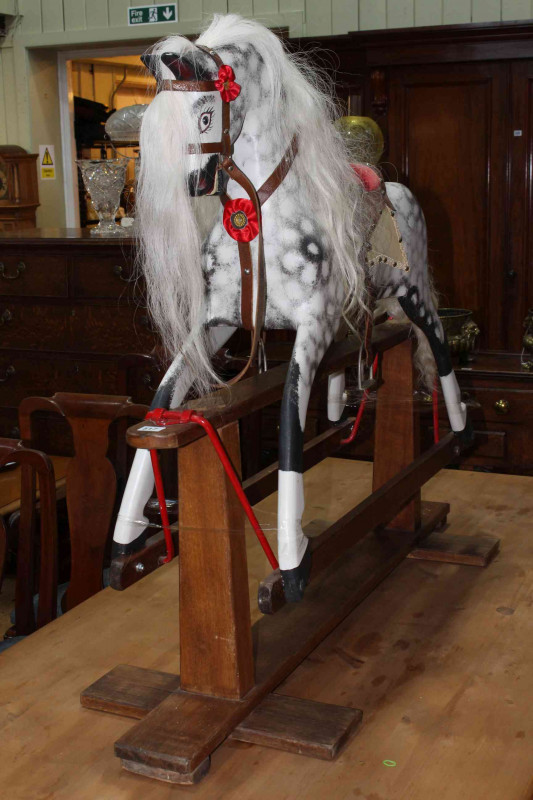Collinson of Liverpool, dappled rocking horse on safety stand, 102cm x 122cm.