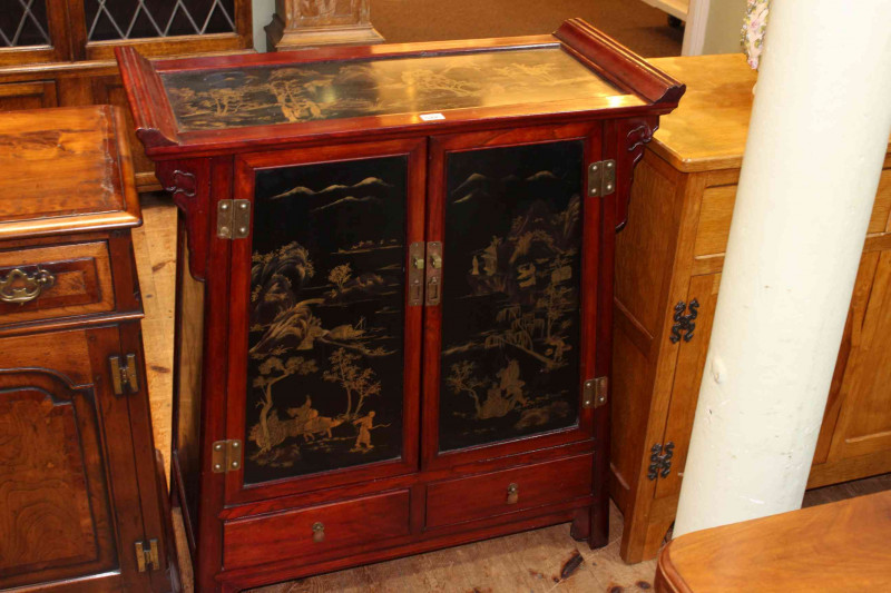 Oriental lacquered cabinet having two lacquered panel doors above two drawers, 93cm by 81.5cm by 38cm.