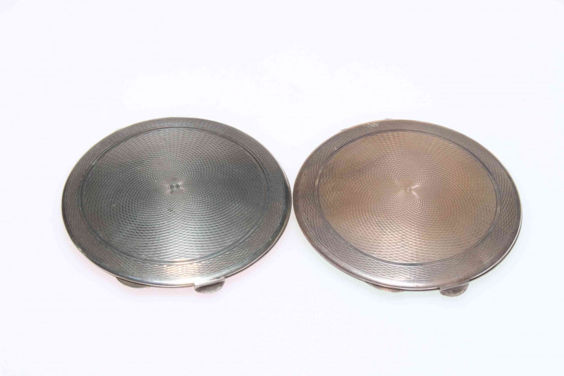 Two Art Deco silver and green and pink guilloché enamel compacts, both Birmingham 1939, 7cm diameter.