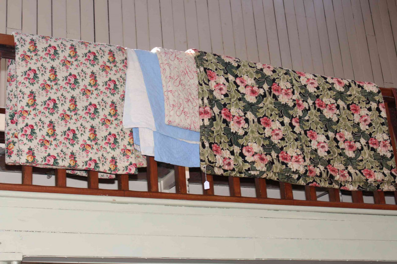 Four various quilts including blue Durham and three floral.