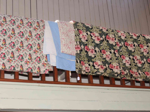 Four various quilts including blue Durham and three floral.