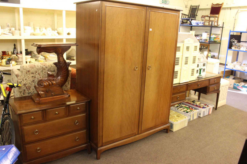 Four piece Stag Minstrel bedroom suite comprising two door wardrobe, five drawer chest, five drawer dressing table and double headboard.