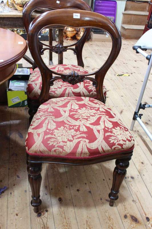Late 19th/early 20th Century oval mahogany dining table on ball and claw legs, 74cm by 120cm by 89cm, together with four later Victorian style mahogany balloon back dining chairs.