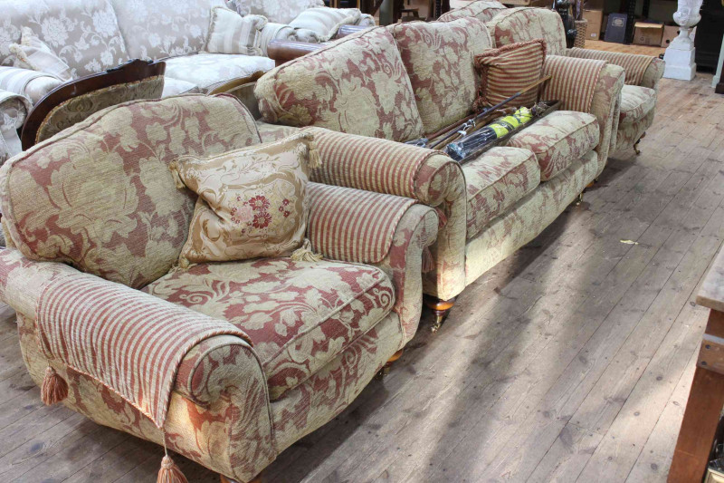 Four piece lounge suite comprising large two seater settee and three armchairs in floral pattern fabric.