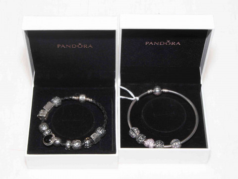 Two Pandora silver charm bracelets.