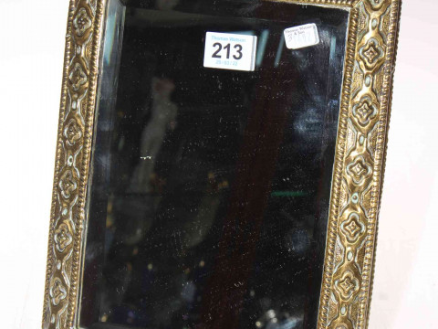 Embossed brass framed bevelled mirror, 28cm by 22cm.