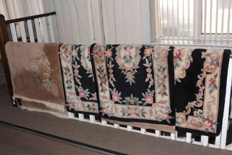 Pair fawn and floral pattern Chinese rugs 1.85 by 0.94 and set of three black and floral pattern Chinese rugs 1.60 by 0.92 (5).
