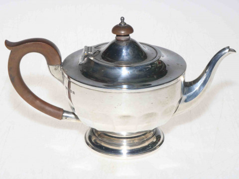 Silver teapot with panelled circular body, 14cm high, Birmingham 1931.