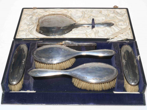 Cased silver six piece brush set with lightly embossed scroll border,...