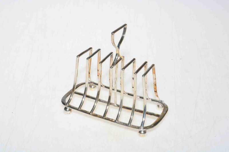 Late Victorian silver seven bar toast rack on ball feet, London 1898.
