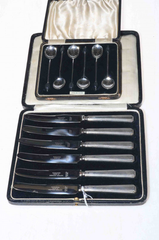 Case of silver handled knives and case of silver spoons (2).