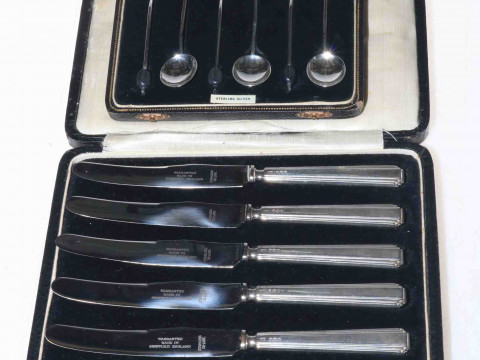 Case of silver handled knives and case of silver spoons (2).