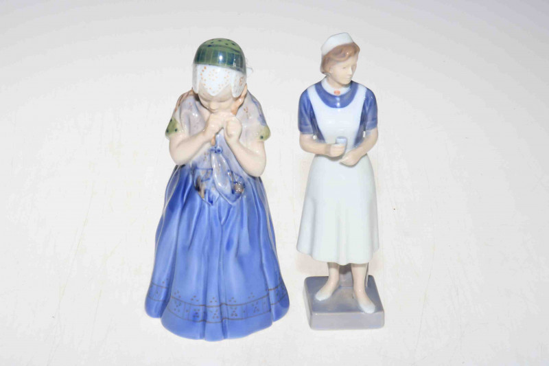Two Royal Copenhagen figures, nurse 4507 and girl from Barnholm 1323, tallest 21.5cm.
