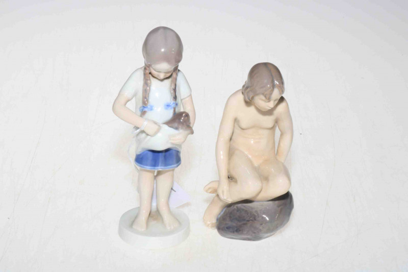 Two Royal Copenhagen figures, naked girl on rock 4027, and girl with kitten 424, tallest 17cm.
