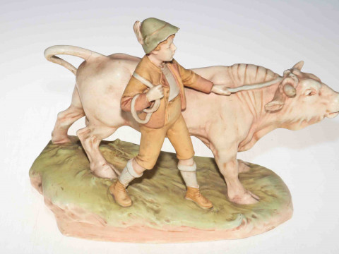 Continental Royal Dux style boy with bull group, printed mark, 39cm wide,...