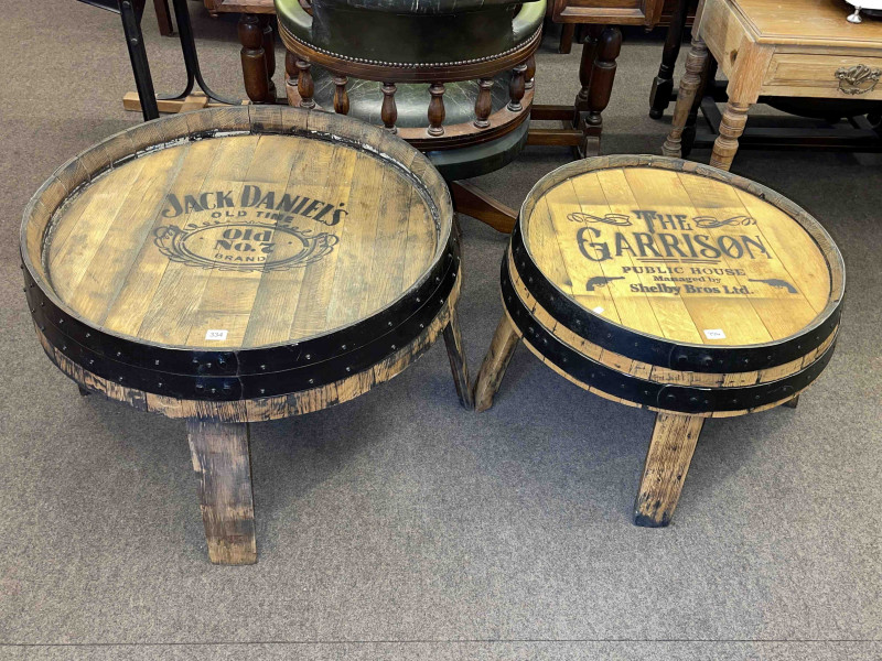 Low barrel bar table 'The Garrison Public House', 46cm by 62cm diameter and low barrel bar table 'Jack Daniels', 50cm by 76cm diameter.