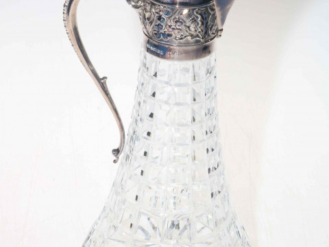 Silver mounted crystal claret jug, with shamrock and thistle decoration,...