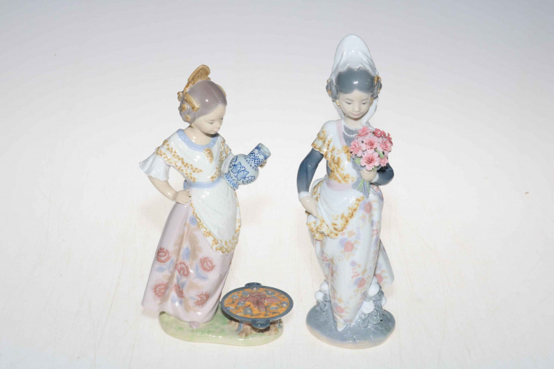 Two Lladro figures, Valencian Girl with Flowers, 1304, 24.5cm, and Woman with Vase and Cooking Paella, 22cm.