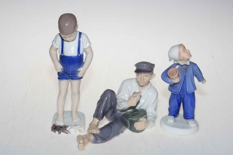 Three Bing & Grondahl and Royal Copenhagen figures, Boy with Crab, Reclining Male and Boy, tallest 19.5cm.