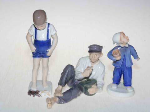 Three Bing & Grondahl and Royal Copenhagen figures, Boy with Crab, Reclining...