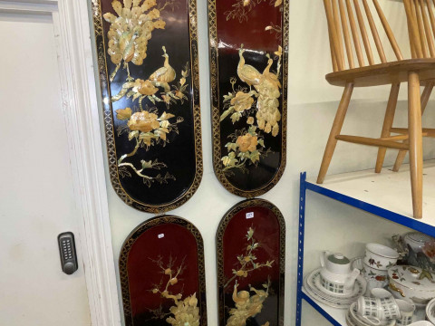 Set of four Chinese panels with applied decoration.