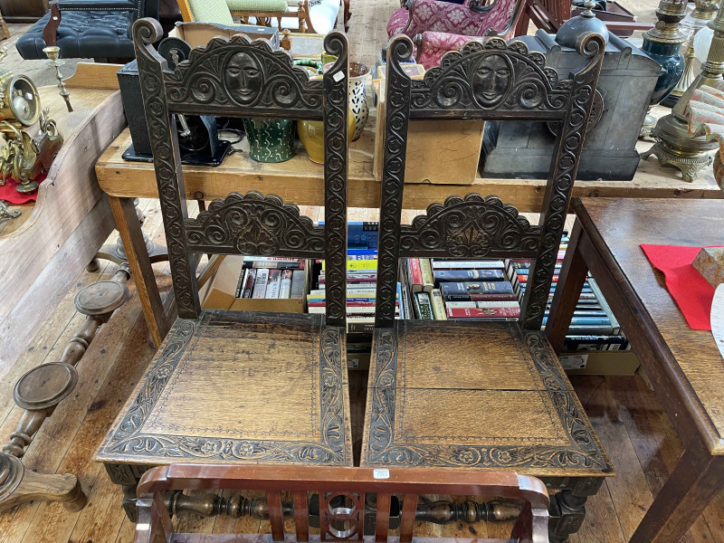 Pair Victorian carved oak hall chairs.