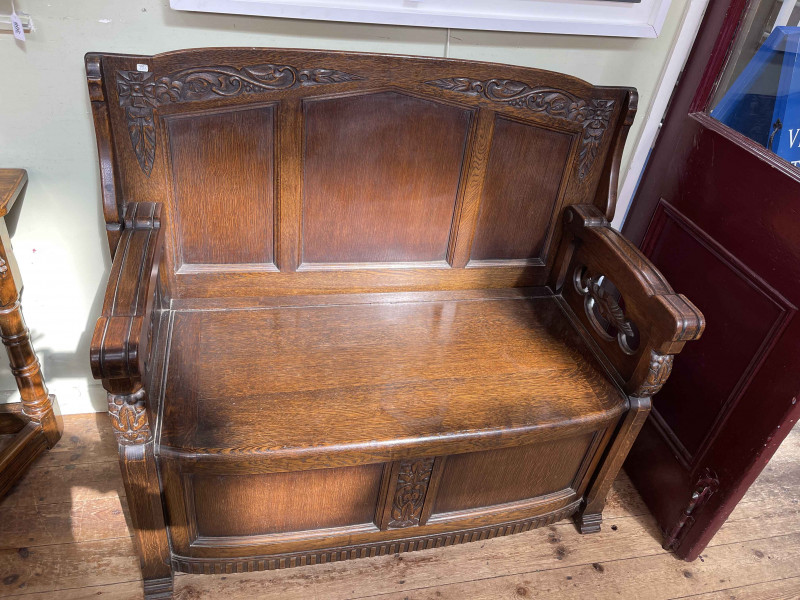 Carved oak monks bench, 75cm by 122cm by 62cm (closed).