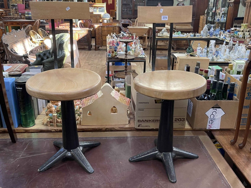 Pair Singer cast base adjustable sewing chairs.