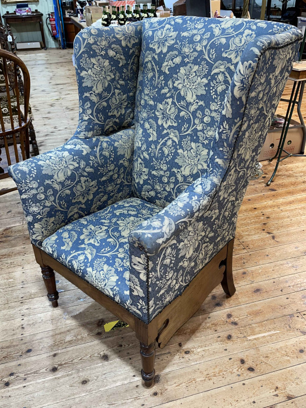 Georgian mahogany wing chair on turned legs.