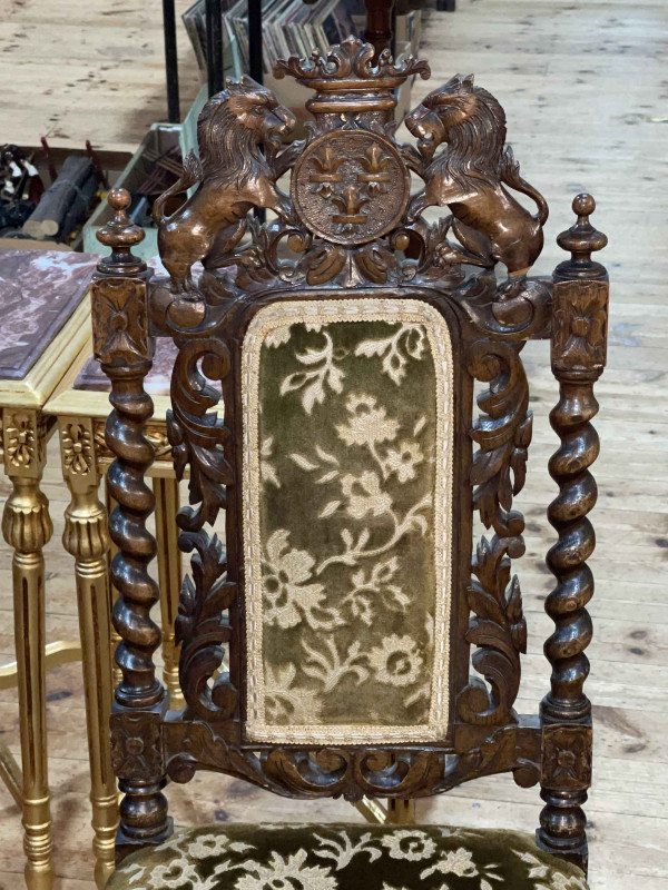 Pair Victorian carved oak side chairs with armorial crests.