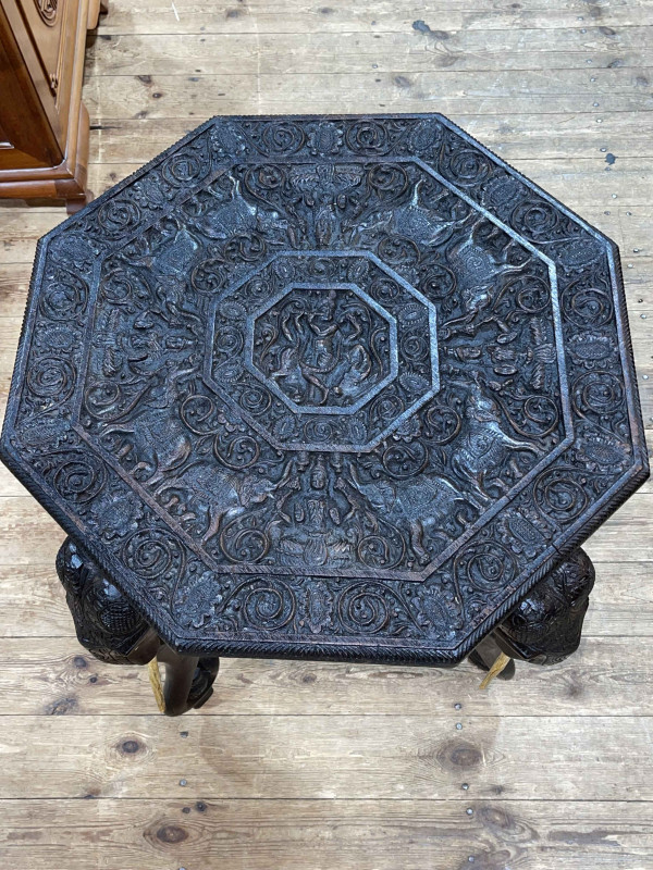 Heavily carved octagonal elephant table, 62cm by 62cm by 62cm.