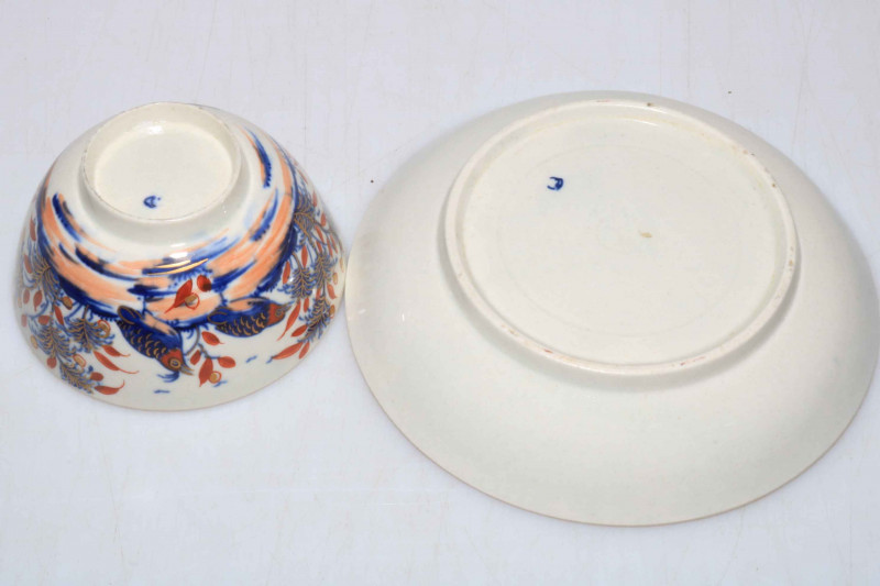 Late 18th Century Worcester tea bowl and saucer decorated with birds, butterfly and fauna in underglaze blue and iron red and gilt.