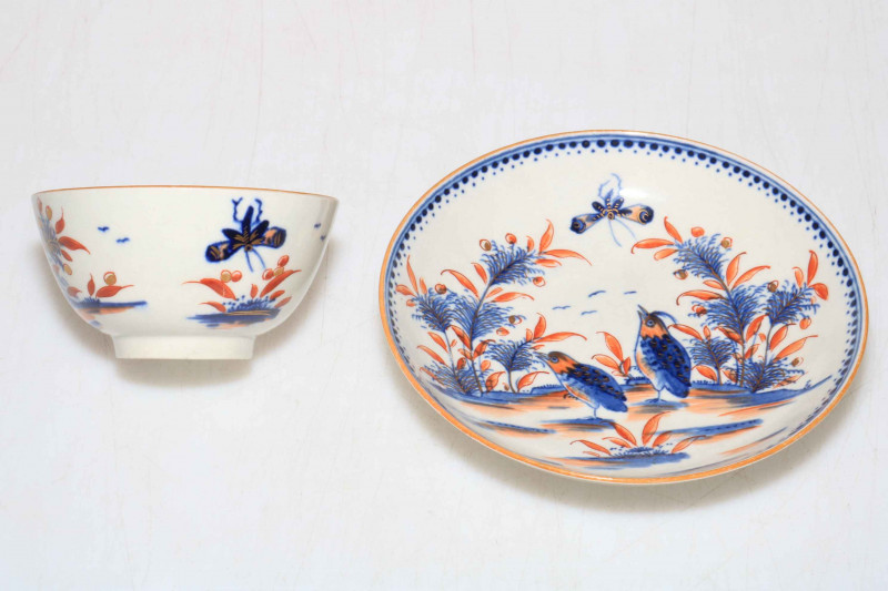 Late 18th Century Worcester tea bowl and saucer decorated with birds, butterfly and fauna in underglaze blue and iron red and gilt.
