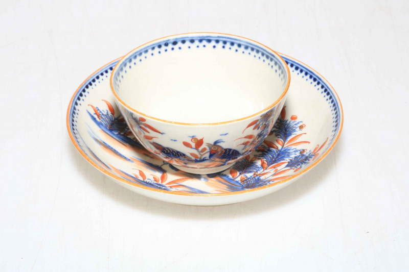Late 18th Century Worcester tea bowl and saucer decorated with birds, butterfly and fauna in underglaze blue and iron red and gilt.