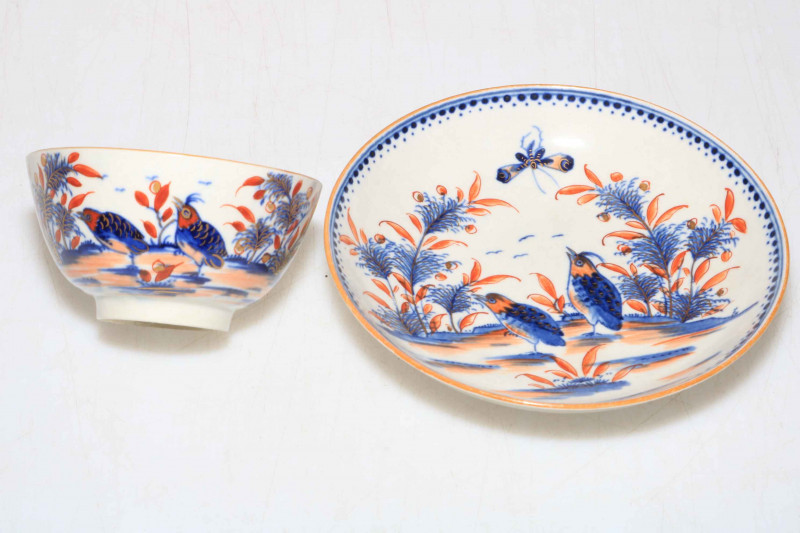 Late 18th Century Worcester tea bowl and saucer decorated with birds, butterfly and fauna in underglaze blue and iron red and gilt.