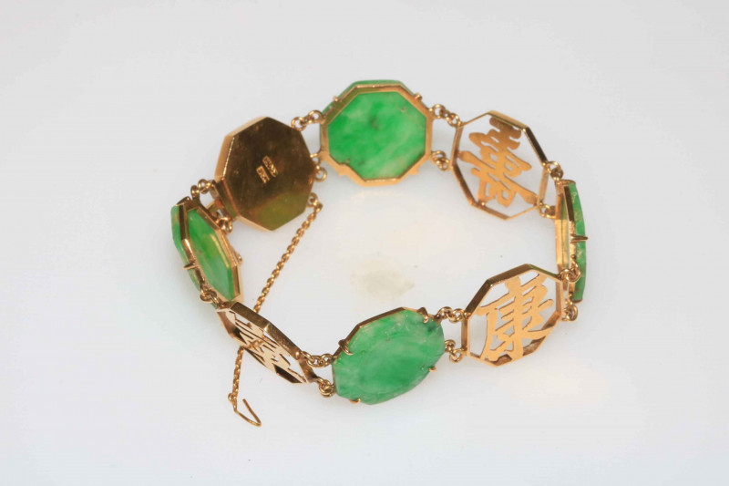 Chinese gold and green jade bracelet, the hexagonal jade panels having scroll chased borders.