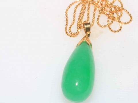 18 carat gold and green jade pendant.