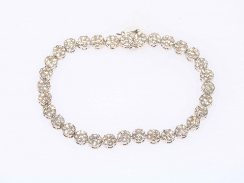 Spectacular diamond tennis bracelet in white gold and having 32 florets...